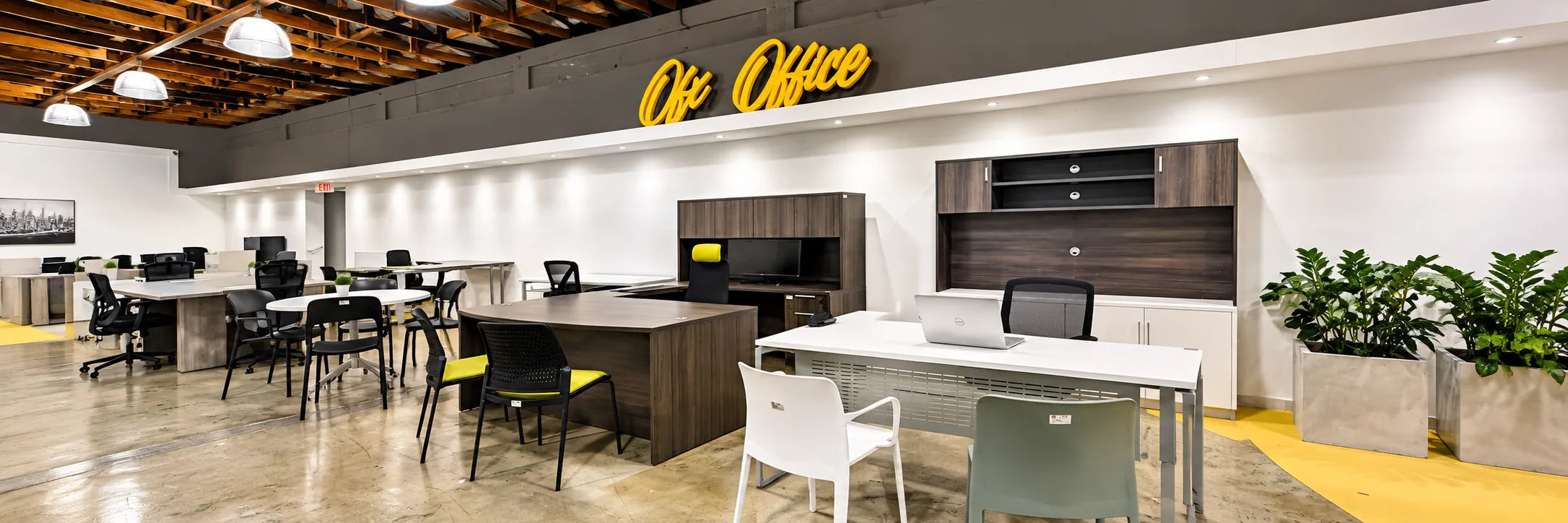 Showroom desks and executive office furniture under the OFX Office sign