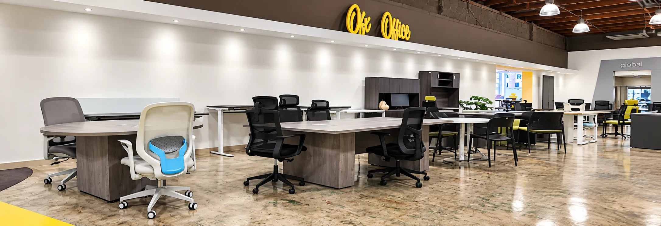 Showroom desks and a conference table under the OFX Office sign