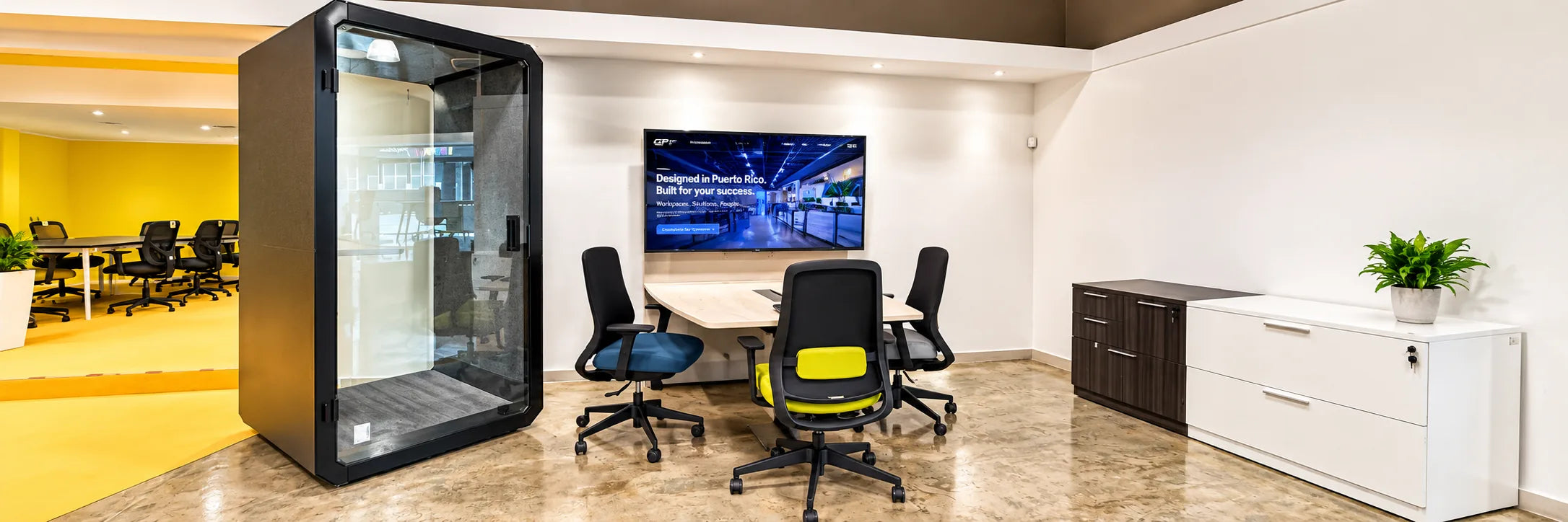 Meeting room with an acoustic phone booth, conference table and screen